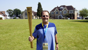 Holding the official Olympic torch in Harpendon, England during 2012 Outreach in London.